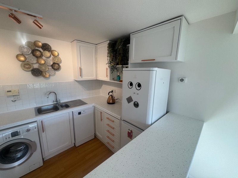 Kitchen decorated in Warlingham with cabinets painted in Benjamin Moore white